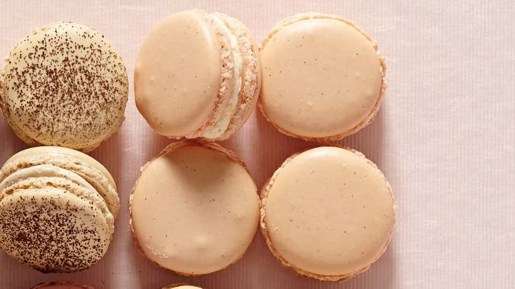 Martha Stewart vanilla bean macarons with crackled almond shells and buttercream filling on a white surface