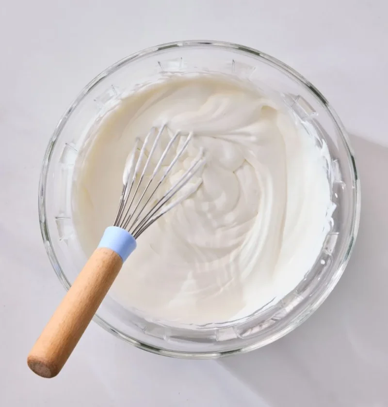 Bowl of Martha Stewart whipped cream with soft billowy peaks, ready to serve