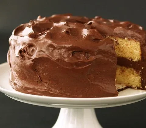 Light and fluffy yellow cake layers on a wire rack, golden crumb showing the airy texture of this martha stewart light and fluffy yellow cake