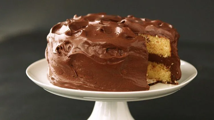 Light and fluffy yellow cake layers on a wire rack, golden crumb showing the airy texture of this martha stewart light and fluffy yellow cake