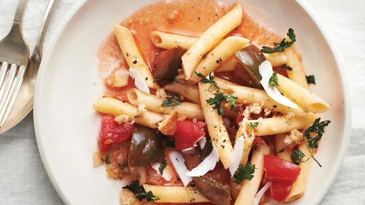 A plate of penne with tomatoes and parsley breadcrumbs, Martha Stewart style, topped with shaved ricotta salata