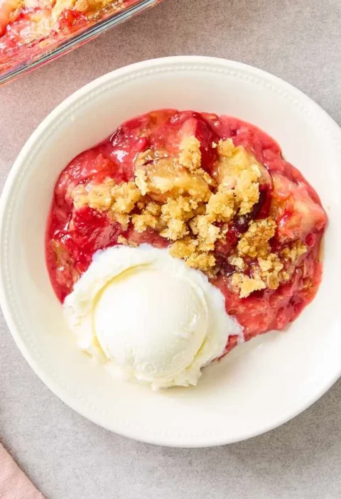Martha Stewart plum oatmeal crisp in a baking dish with golden brown oat topping over baked plums