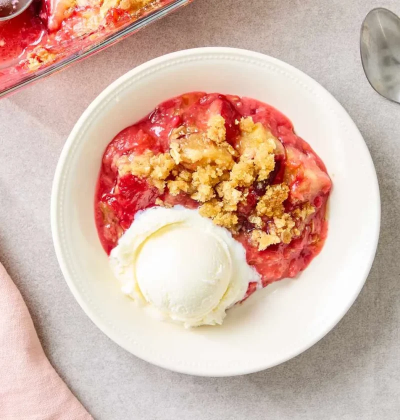 Martha Stewart plum oatmeal crisp in a baking dish with golden brown oat topping over baked plums
