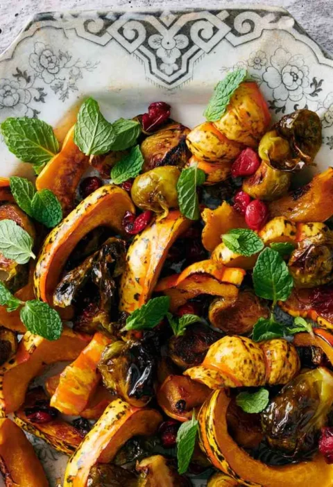 Roasted Brussels sprouts and winter squash with cranberries on a sheet pan, caramelized and golden brown