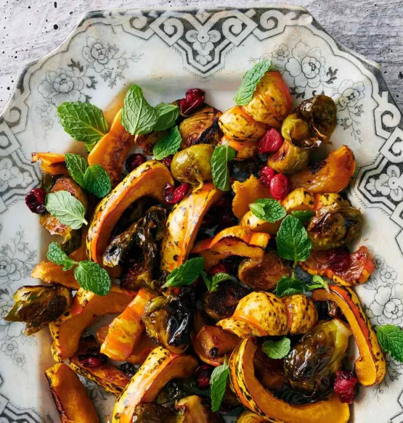 Roasted Brussels sprouts and winter squash with cranberries on a sheet pan, caramelized and golden brown