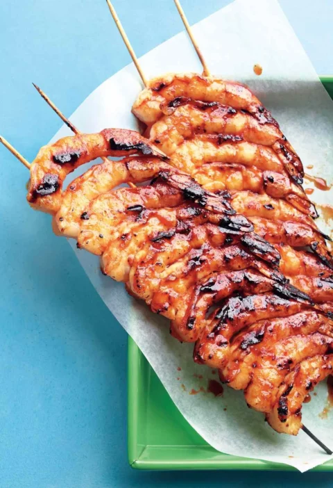 Spicy-sweet glazed shrimp on double skewers with golden honey-sriracha caramelized coating