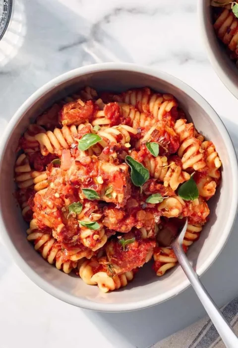 Tuna tomato pasta tossed with penne in a thick crushed tomato sauce with red pepper flakes
