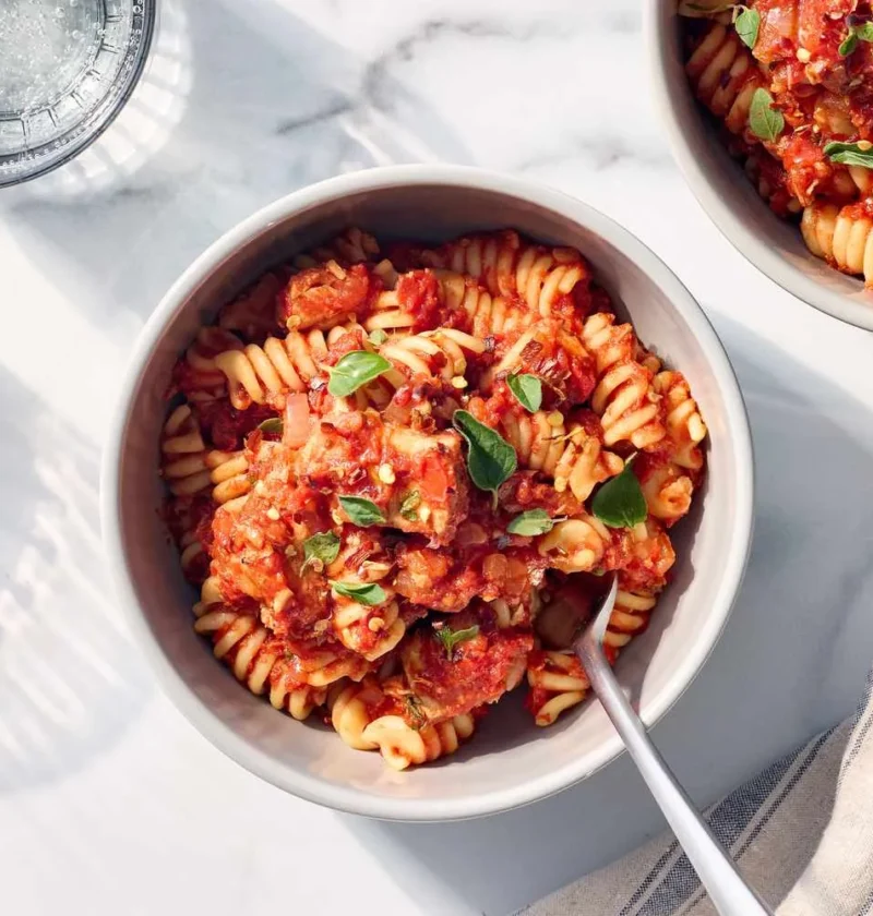 Tuna tomato pasta tossed with penne in a thick crushed tomato sauce with red pepper flakes