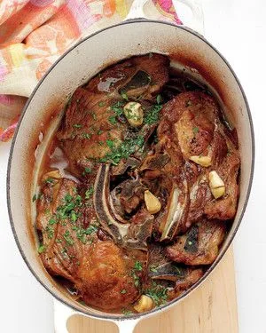 Martha Stewart's vinegar-braised pork shoulder chops in a Dutch oven with glossy pan sauce
