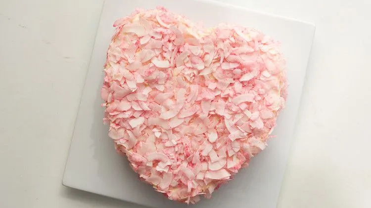 Martha Stewart Alexis' Heart Cake covered in pink coconut flakes on a white square plate