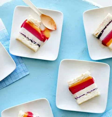 Slices of striped ice cream cake with angel food cake layers on white square plates, an example of Martha Stewart angel food sheet cake for striped ice cream cake