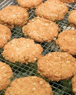 Martha Stewart Anzac biscuits, golden oat and coconut cookies cooling on a wire rack