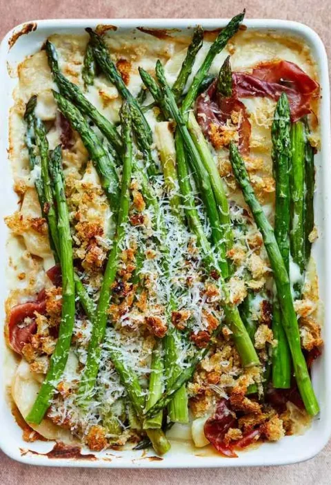 Martha Stewart asparagus-and-potato gratin with prosciutto in a white baking dish topped with breadcrumbs and Pecorino