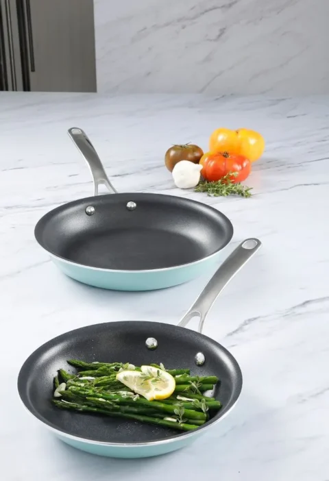 Martha Stewart asparagus vinaigrette: blanched asparagus spears with a lemon slice and fresh herbs in a nonstick skillet