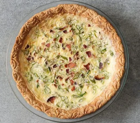 Martha Stewart bacon and scallion quiche in a golden crust topped with crumbled bacon and sliced scallions