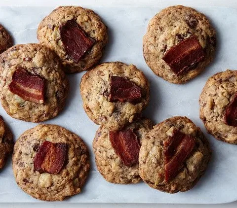 Martha Stewart bacon potato-chip chocolate cookies topped with strips of crispy bacon on a white marble board