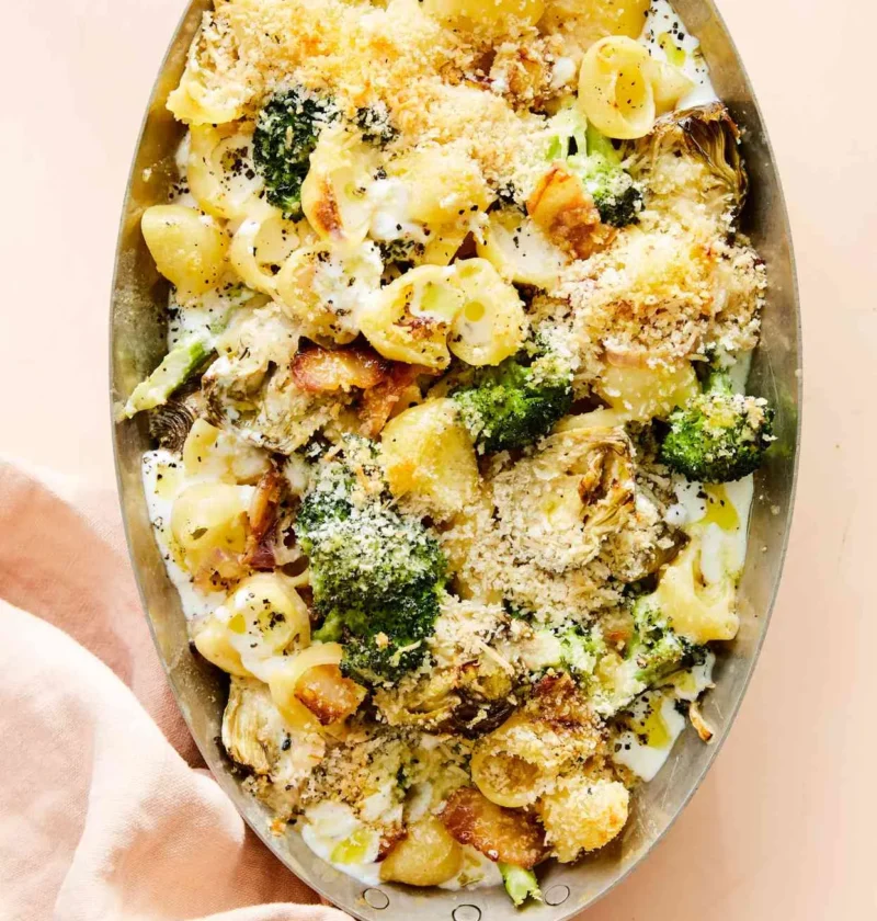 Martha Stewart baked broccoli-and-artichoke shells in an oval dish with golden panko topping, bacon and broccoli florets