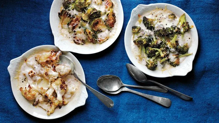 Martha Stewart baked cauliflower custards in white gratin dishes with bubbly golden cheese on a blue cloth