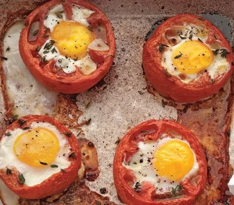 Martha Stewart baked eggs in whole roasted tomatoes with runny yolks in a roasting dish