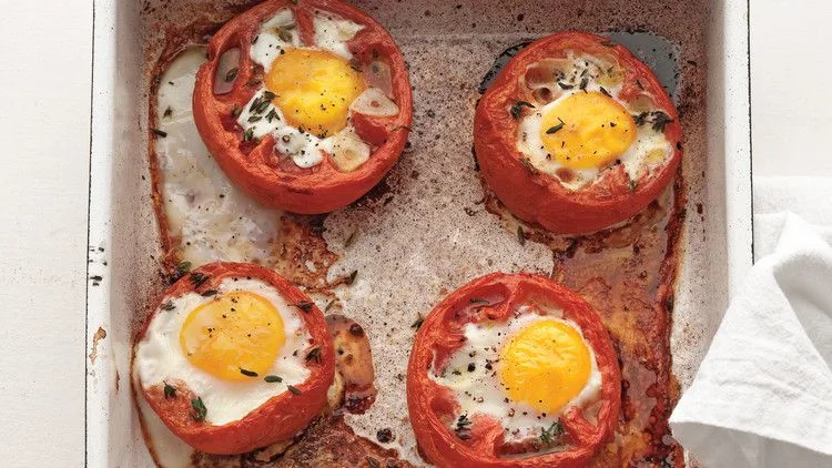 Martha Stewart baked eggs in whole roasted tomatoes with runny yolks in a roasting dish