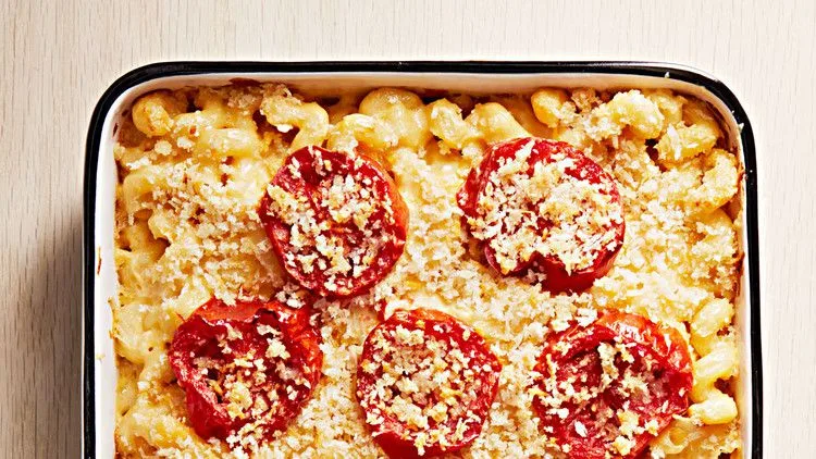Martha Stewart baked mac and cheese with broiled tomatoes and a golden panko topping in a baking dish