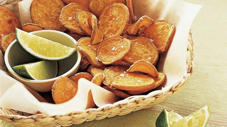 Martha Stewart baked sweet-potato chips in a woven basket with lime wedges on the side