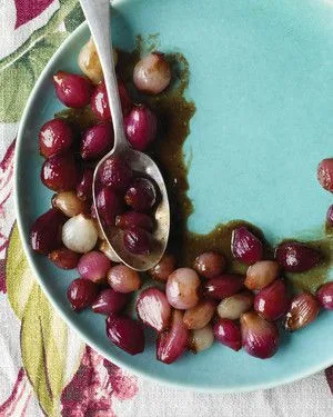 Martha Stewart balsamic-glazed pearl onions, red and white, on a teal plate with a silver spoon and dark glaze