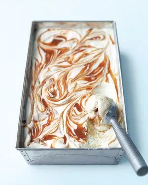 Martha Stewart banana-caramel ice cream swirled with caramel in a metal loaf pan with an ice cream scoop