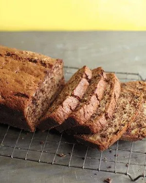 Martha Stewart banana-chocolate bread sliced on a wire cooling rack, showing a moist crumb with chocolate pieces