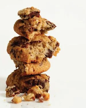 Stack of Martha Stewart banana-walnut chocolate chunk cookies broken open to show chocolate chunks and walnuts