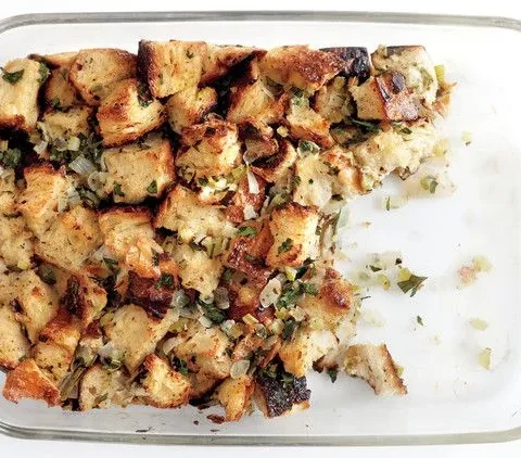 Martha Stewart basic bread stuffing baked golden brown with herbs in a glass baking dish