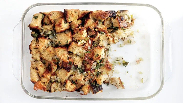 Martha Stewart basic bread stuffing baked golden brown with herbs in a glass baking dish