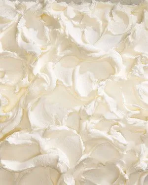 Martha Stewart basic buttercream spread in soft creamy swirls on top of a cake