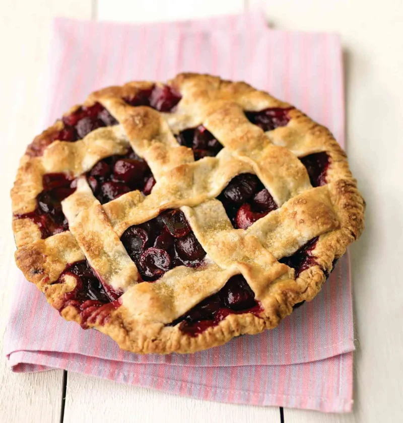 Martha Stewart basic pie dough for sweet cherry pie baked into a golden lattice crust over dark cherry filling