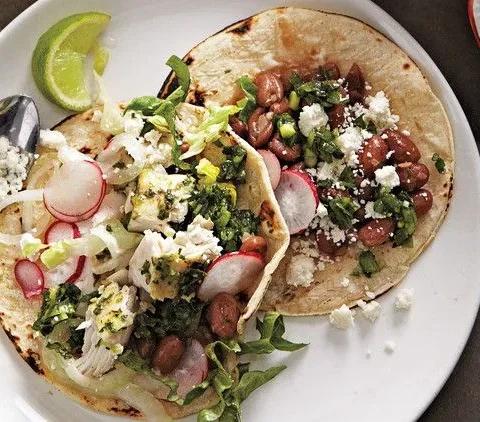 Martha Stewart bean-and-fish tacos on corn tortillas with pinto beans, sliced radishes, cotija cheese and lime wedges