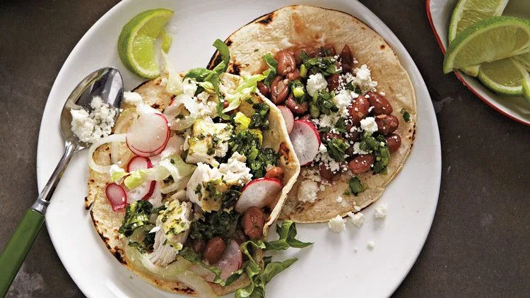 Martha Stewart bean-and-fish tacos on corn tortillas with pinto beans, sliced radishes, cotija cheese and lime wedges