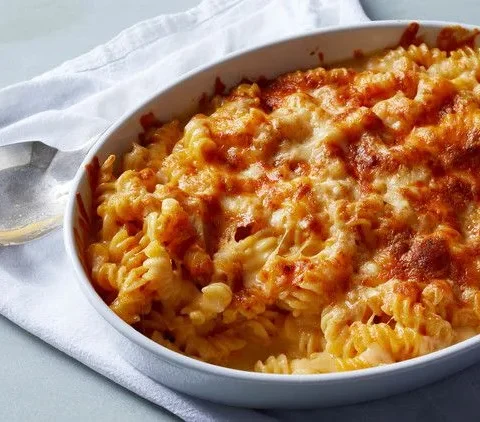 Martha Stewart Beecher's Flagship cheese sauce baked over rotini pasta in a white oval dish with a golden browned top