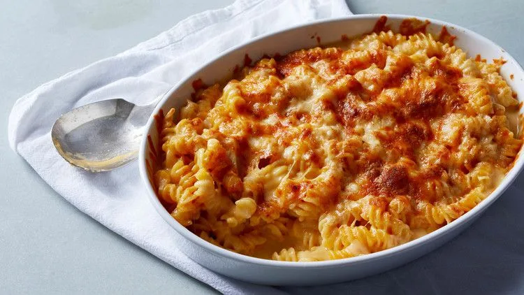Martha Stewart Beecher's Flagship cheese sauce baked over rotini pasta in a white oval dish with a golden browned top