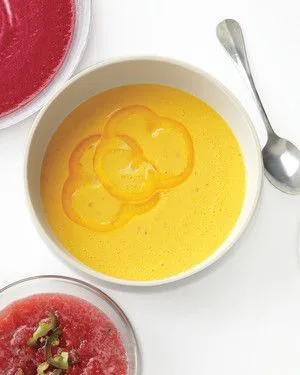 Martha Stewart bell pepper, yogurt, and harissa soup in a white bowl topped with thin yellow pepper slices