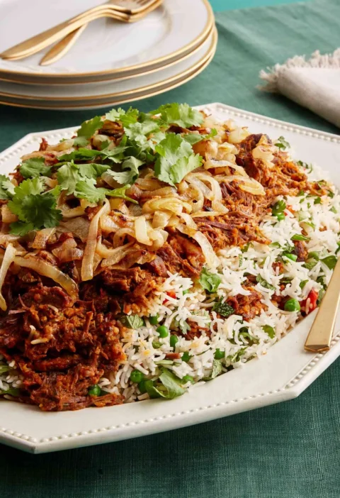 Beef biryani with caramelized onions, peas and cilantro on white rice, made with Martha Stewart biryani spice blend