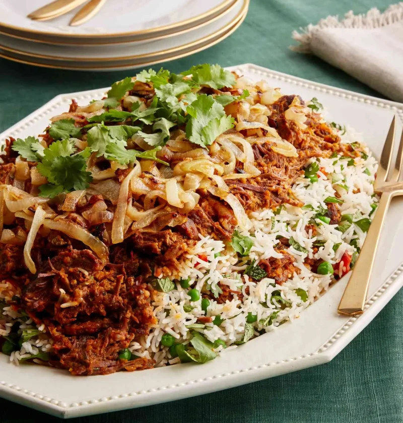 Beef biryani with caramelized onions, peas and cilantro on white rice, made with Martha Stewart biryani spice blend