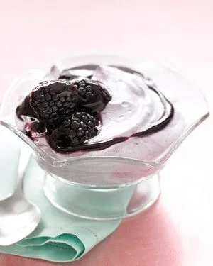Martha Stewart blackberry fool in a glass dish topped with fresh blackberries and a glossy berry puree drizzle