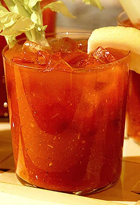 Martha Stewart Bloody Mary in a glass over ice with a celery stalk and lemon wedge garnish