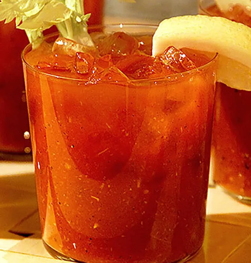 Martha Stewart Bloody Mary in a glass over ice with a celery stalk and lemon wedge garnish