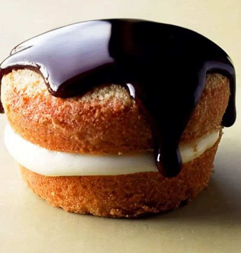 Martha Stewart Boston Cream Pie Cupcakes with vanilla cream filling and chocolate ganache dripping down the golden cake