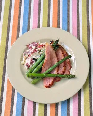 Martha Stewart bourbon-glazed ham slices served with grilled asparagus and potato salad on a cream plate